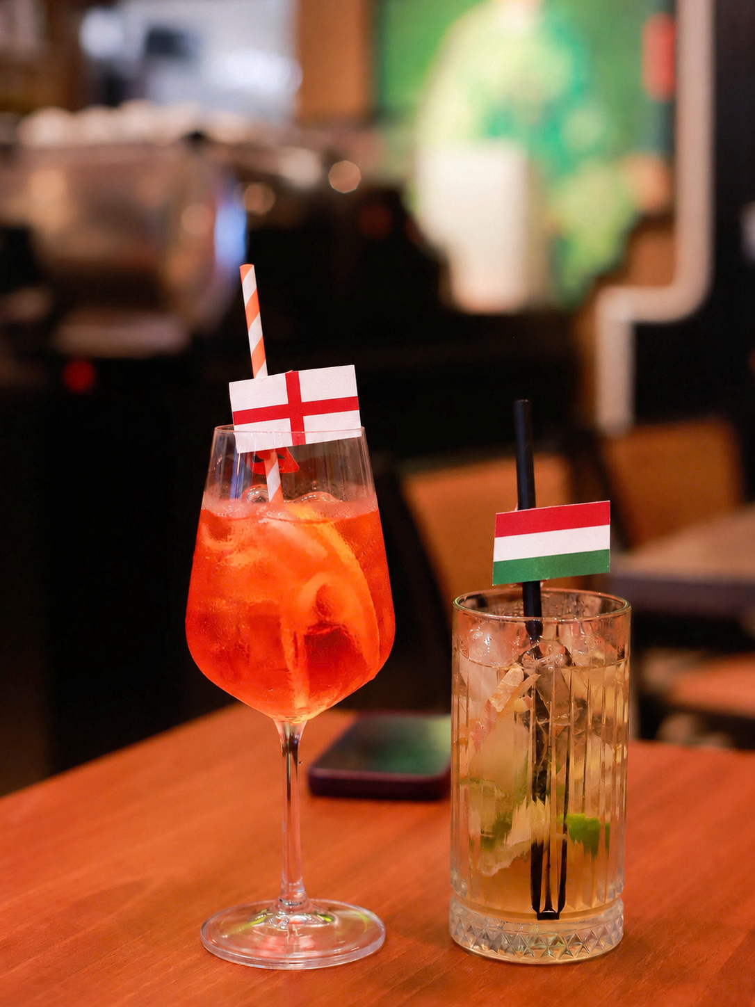 Two drinks marked with Hungarian and English table flags, symbolizing a language exchange