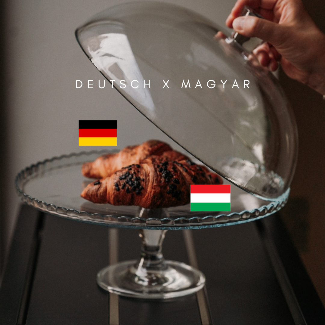 Pastry under a glass dome with German and Hungarian table flags